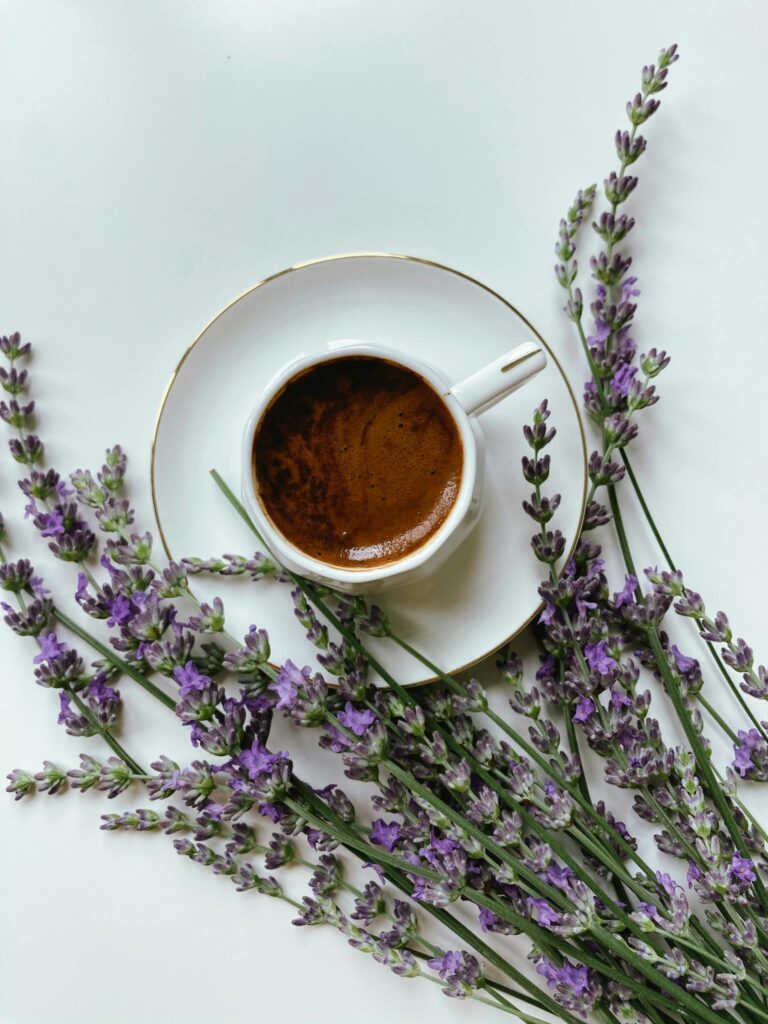 A top view of a porcelain coffee cup with aromatic lavender sprigs, perfect for relaxing moments.